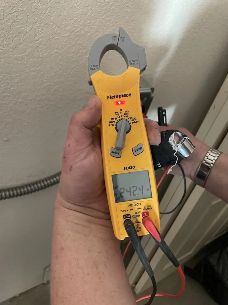 Voltage testing with clamp meter during Outlet Installation in Harrison